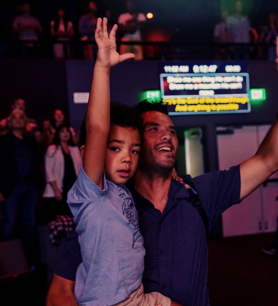 Mark with his son at church worship